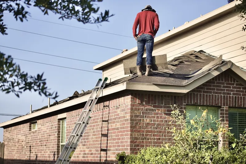 Professional roofer working on a residential roof in Normandale Highlands